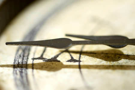 concept of time with the detail of a hand of an old clockの写真素材