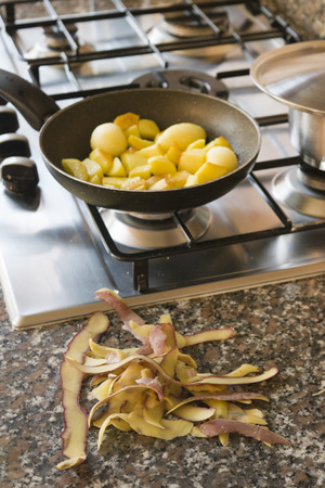 crispy fried new potatoes frying in panの写真素材