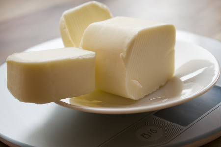 blocks of butter on a kitchen scaleの写真素材