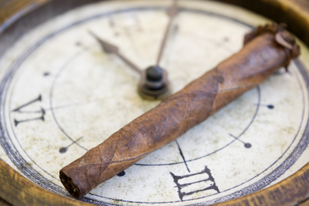 smoking and medical treatment with a cigar and a blister of pillsの写真素材