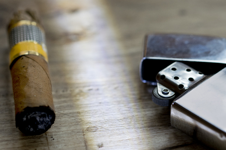 just unlit Havana cigar with a metallic cigarette lighterの写真素材