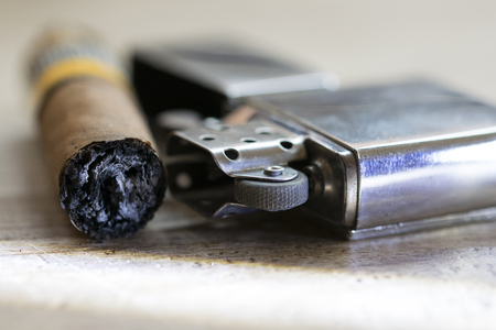 Havana cigar just smoked and petrol metallic lighterの写真素材