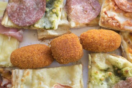 tasting food of rotisserie or variety of pizza croquettes and rice balls