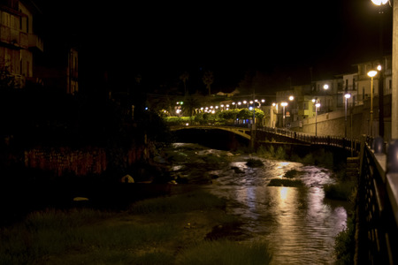 night view of a river in the historical centre of an ancient villageの写真素材