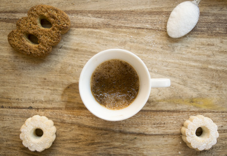 top view of a cup of espresso coffee with biscuits and sugar の写真素材