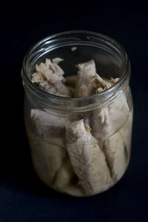 homemade fillet of tuna in olive oil and preserved in glass jarの写真素材