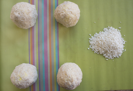 just prepared sicilian arancini with their typical  filling before being fried