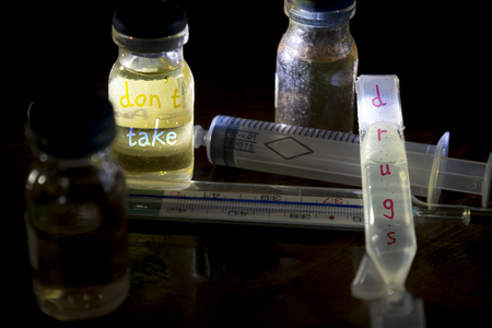 message against the drugs written on a medicinal flacons