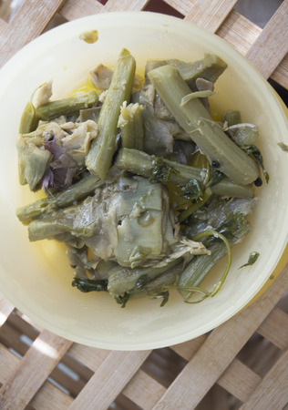 flat lay of stewed artichokes seasoned with oil garlic and lemonの写真素材