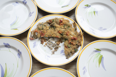 baked anchovy pie au gratin between a series of white dishesの写真素材
