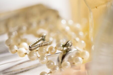 Necklace of stone pearl on illumined glass backgroundの写真素材