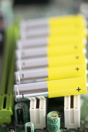 Colored alkaline batteries organized on a electronic boardの写真素材