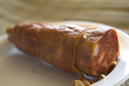 handmade calabrese soppressata on a white plastic dishの写真素材