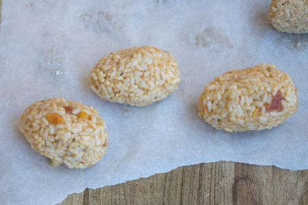 preparing Italian fried rice balls or arancini