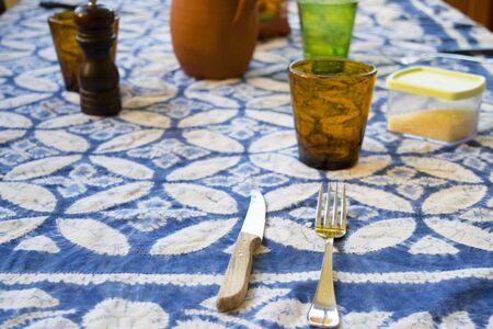 home table set very simply with cutlery and glass