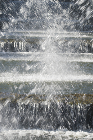 plays of spashes of water from the spouts of a seies of fountainの写真素材