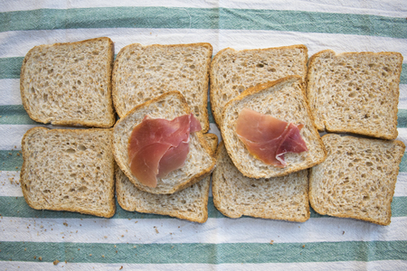 top view of the preparation of a wholemeal sandwich with cured hamの写真素材