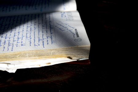 old manuscript diary illumined from lateral lightのeditorial素材