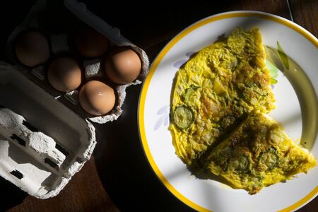 wedges of vegetarian frittata with near fresh eggsの写真素材