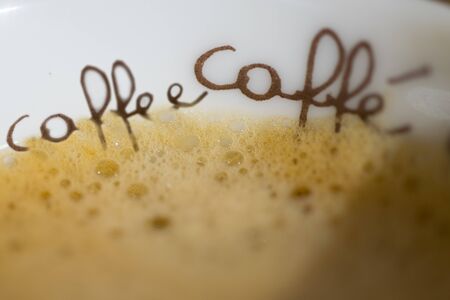 detail of a written coffee and the cream in a small cupの写真素材