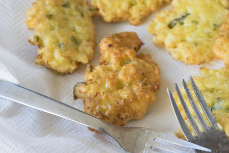vegetarian crispy fritters just fried and disposed on absorbent kitchen towel