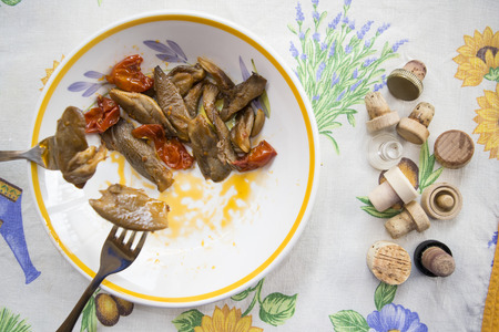 stewed mushrooms in pan with cherry tomatoes and garlicの写真素材