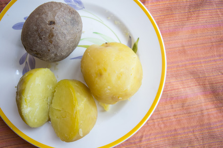  boiled potato whithout peel approached to one with the peelの写真素材