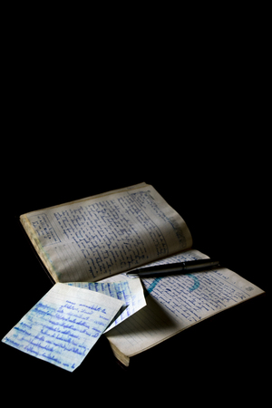 old manuscript with handwritten letters on black backgroundの写真素材