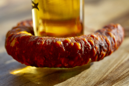 homemade calabrian salami with reflections through an oil bottleの写真素材