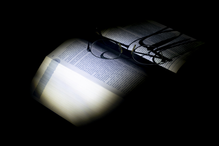 lights and shadows on an old manucript with a pair of specsの写真素材