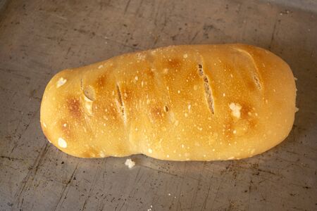 loaf of bread made in the home oven on a metallic tray