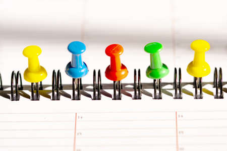 colored push pins on a page on a planning