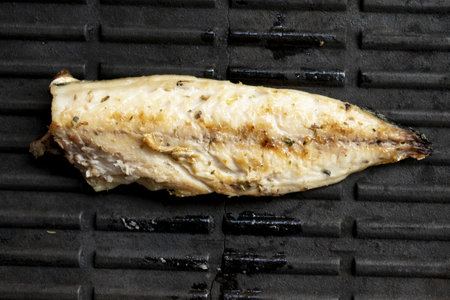 a griddle during the cooking of a fresh mackerel fillet