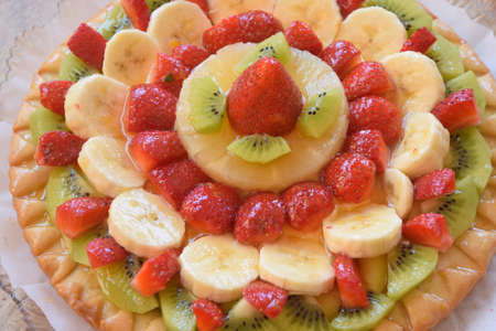 homemade tart with assorted colored summer fruitの写真素材