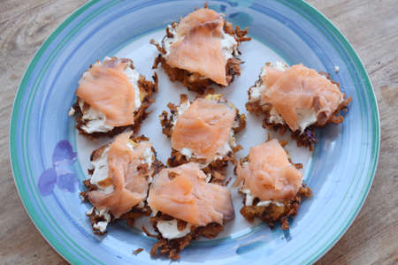 A plate of swiss rÃ¶sti with cheese and smoked salmon