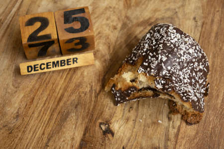 December 25th Christmas party with the date written on wooden dice and a chocolate dessert