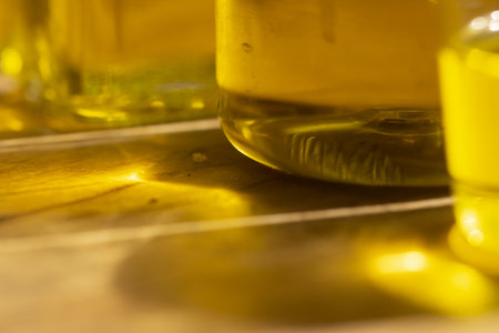 colors reflections and lights through detail of oil bottlesの写真素材