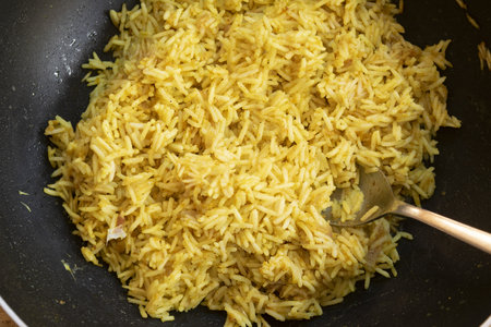 saffron risotto in a wok ready to be servedの写真素材