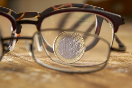 1 euro coin seen through an eyeglassの写真素材