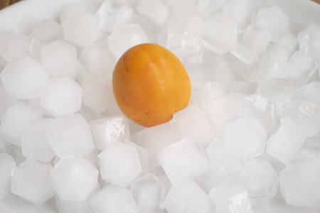 cold fruit in summer : peach dipped in ice cubesの写真素材