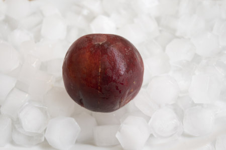 peach fruit in a series of ice cubesの写真素材