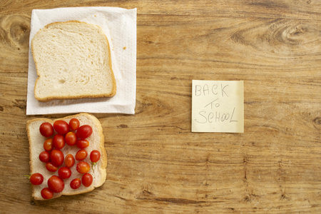 back to school concept with a sandwich and writingの写真素材