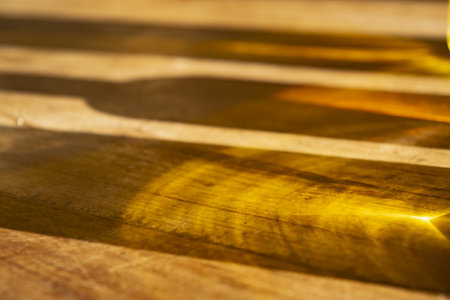 colorful reflections of some bottles on a wooden tableの写真素材