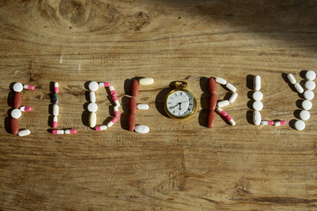 old age concept with the writing elderly made with pillsの写真素材