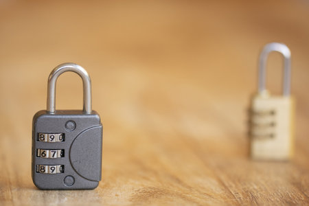 concept of safety with two combination lock on a wooden tableの写真素材