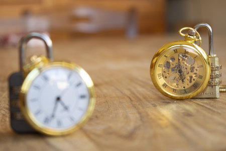 time concept with two old pocket watches and a combination lock