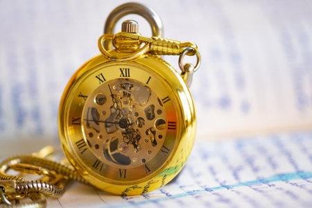 time concept with an old pocket watch remaining on a manuscriptの写真素材