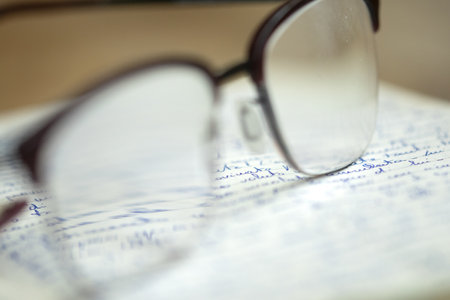 handwritten sheet with the writing seen through a pair of glassesの写真素材