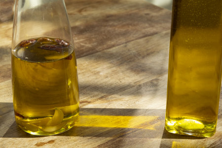 bottle of homemade flavored olive oil on a wooden tableの写真素材