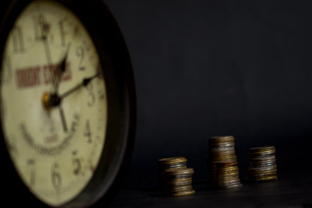 concept of time and business with an old clock and some moneyの写真素材